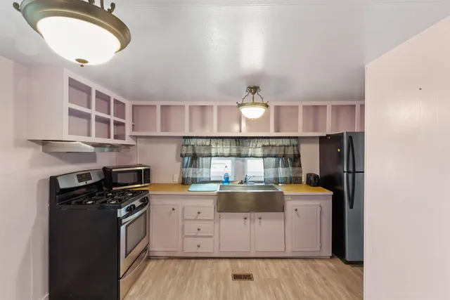 a kitchen with stainless steel appliances granite countertop a stove and a refrigerator