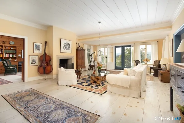 a living room with fireplace furniture and a fireplace