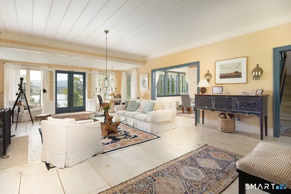 a living room with furniture a dining table and a table