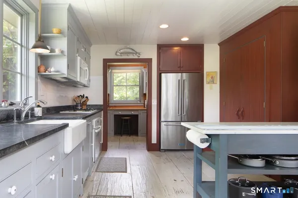 a kitchen with a sink appliances and cabinets
