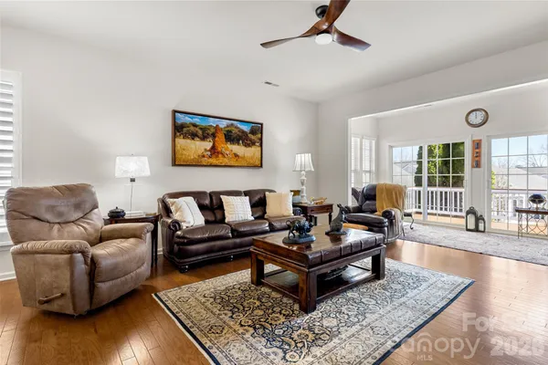 a living room with furniture and a floor to ceiling window