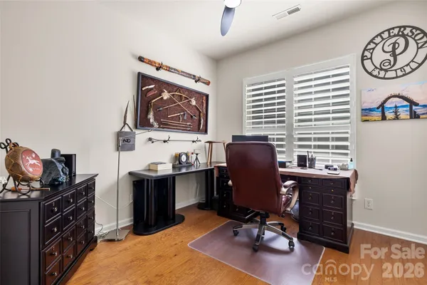 a spacious bedroom with a bed and a large window