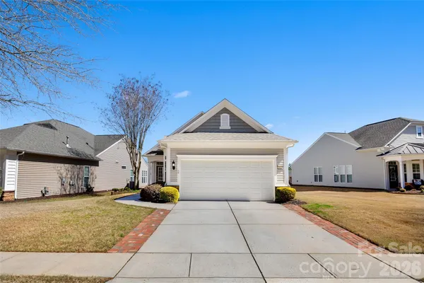 a kitchen with wooden cabinets and stainless steel appliances
