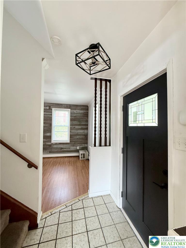 5540 Main Street Whitehall, PA 18052 - Photo 17 of 53 A welcoming entry features a stylish light fixture and durable tile flooring leading into sun-drenched interiors.