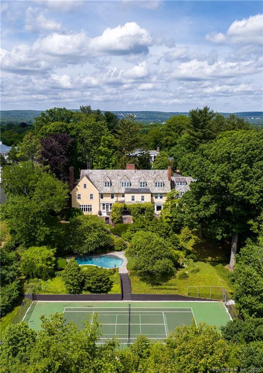 Stunning Aerial shot of the exterior of the home, pool and tennis courts.
