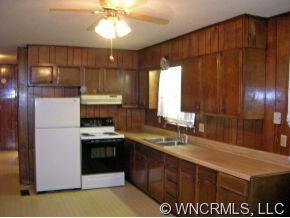 394 Whiteside Road Rutherfordton, NC 28139 - Photo 6 of 12 a kitchen with a sink a refrigerator and cabinets