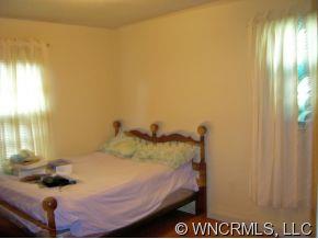 394 Whiteside Road Rutherfordton, NC 28139 - Photo 7 of 12 a bed sitting in a bedroom next to a window