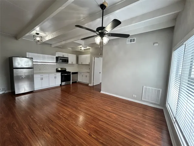 a view of a kitchen with a sink and a refrigerator
