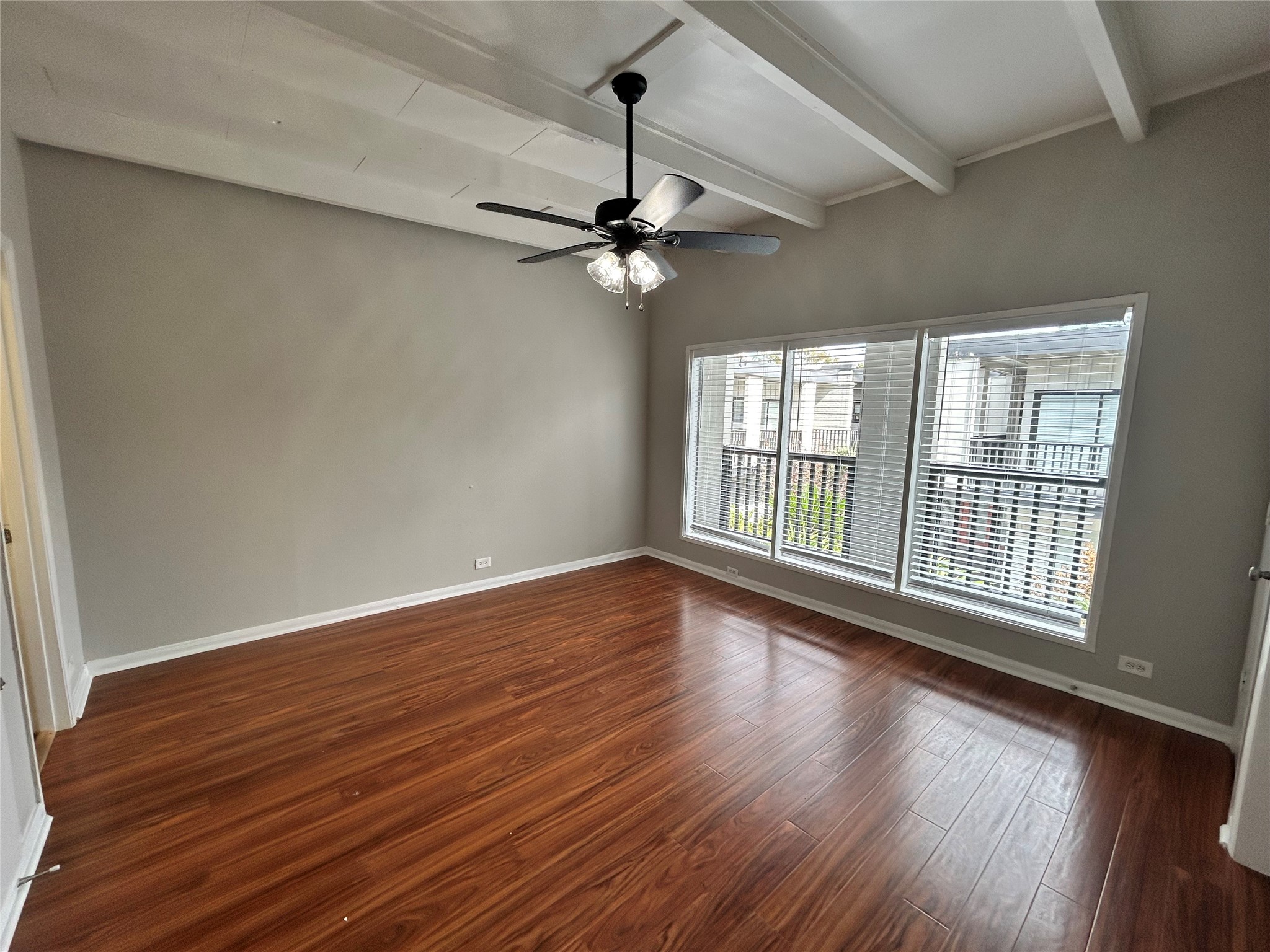 219 Marshall Street, Unit 216 Houston, TX 77006 - Photo 6 of 10 a view of an empty room with a window and wooden floor