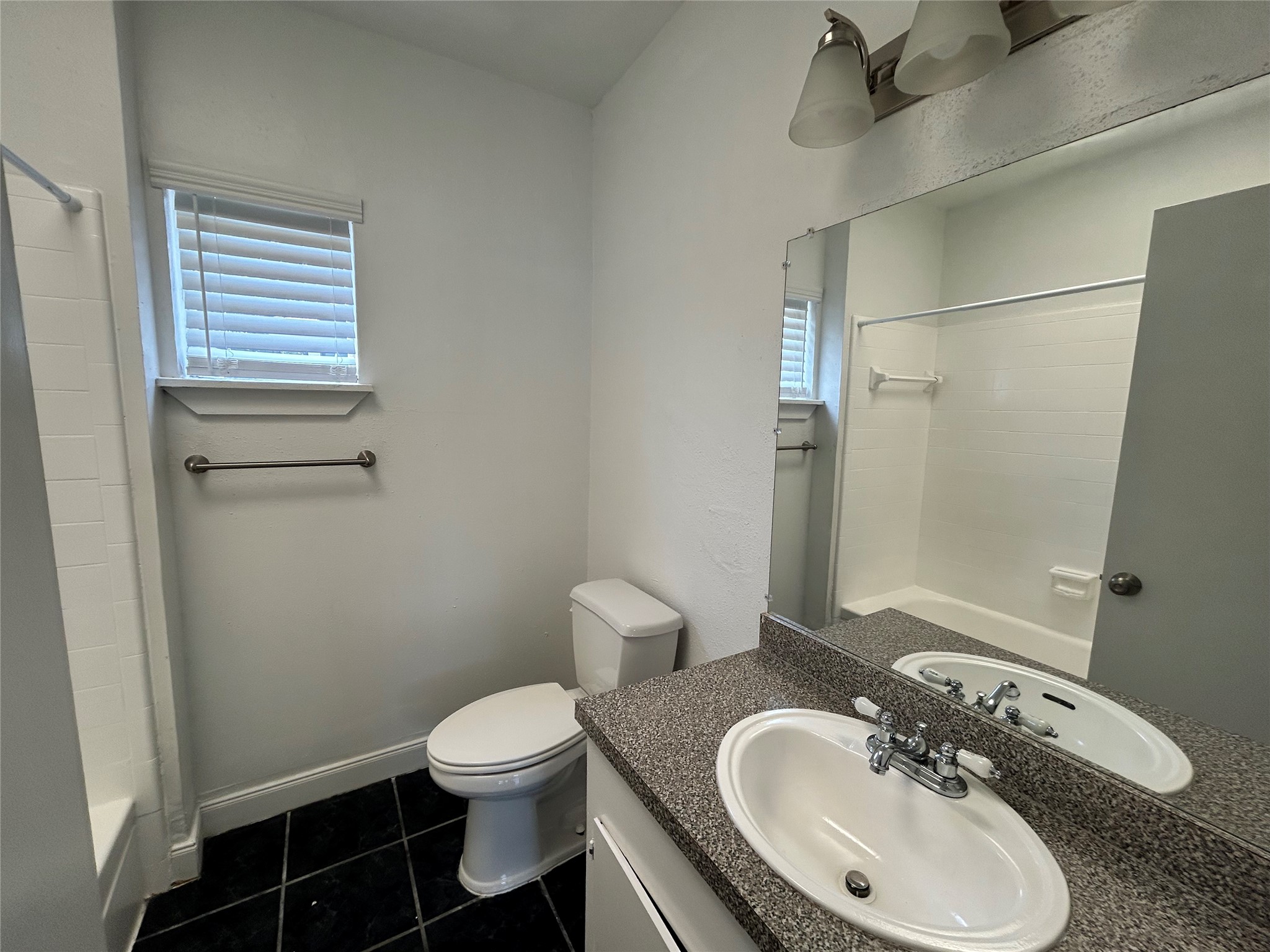 219 Marshall Street, Unit 216 Houston, TX 77006 - Photo 7 of 10 a bathroom with a sink toilet and a mirror