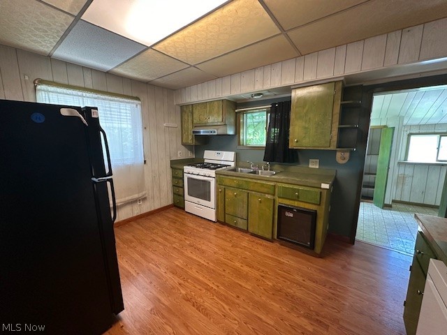 3231 Riverside Avenue Cleveland, OH 44109 - Photo 3 of 37 Kitchen with gas range gas stove, a paneled ceiling, light hardwood / wood-style flooring, and black refrigerator