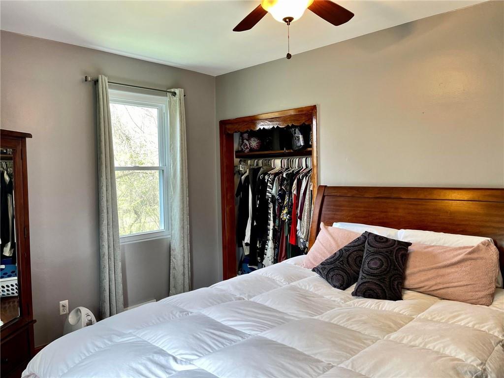 700 Ottillia Street Pittsburgh, PA 15210 - Photo 11 of 20 a bedroom with a bed and a chandelier