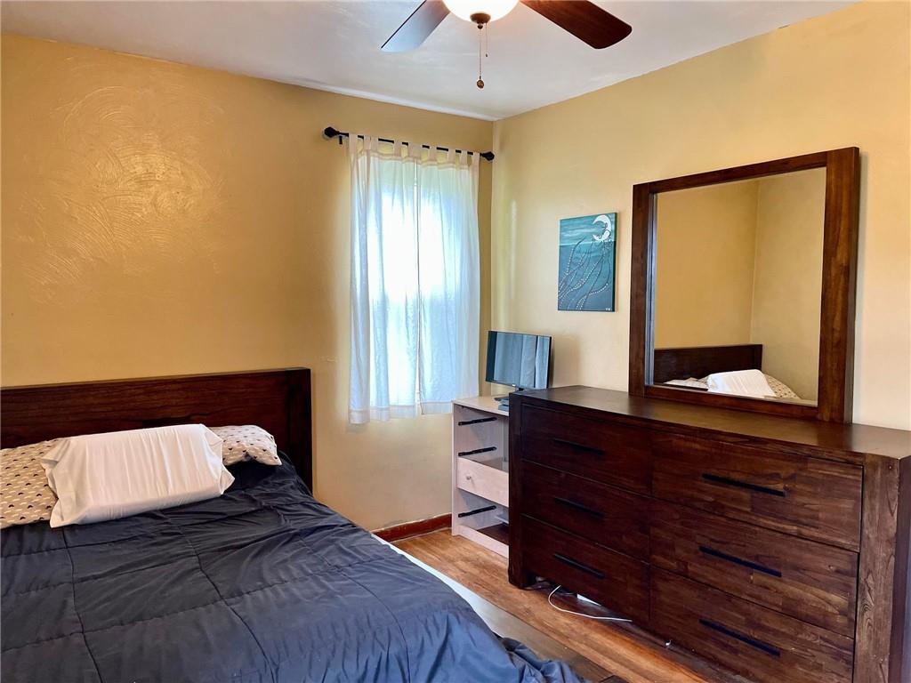 700 Ottillia Street Pittsburgh, PA 15210 - Photo 15 of 20 a bedroom with a bed and a dresser