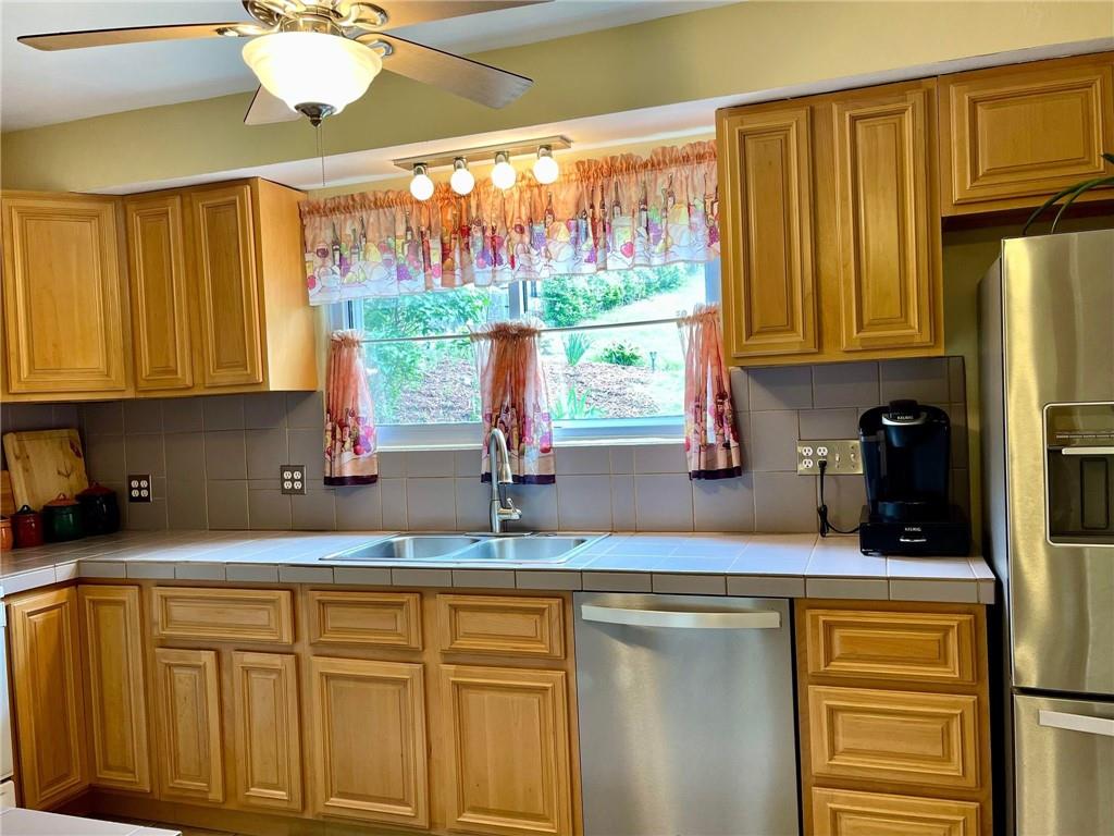 700 Ottillia Street Pittsburgh, PA 15210 - Photo 4 of 20 a kitchen with stainless steel appliances granite countertop a refrigerator and a sink