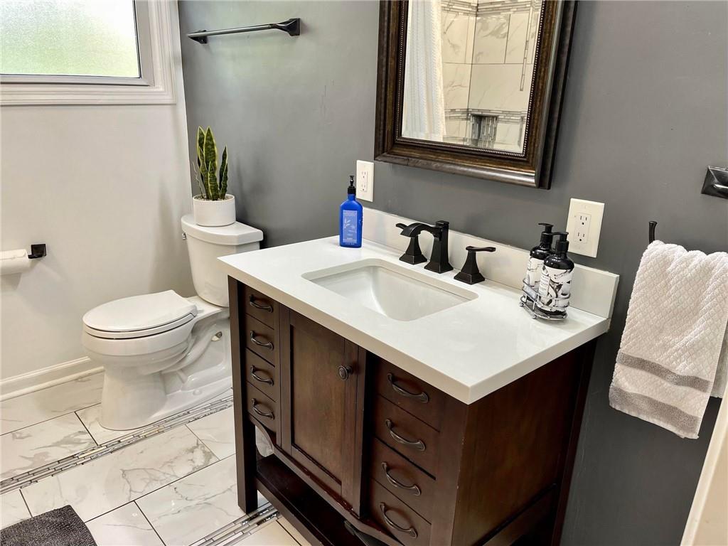 700 Ottillia Street Pittsburgh, PA 15210 - Photo 8 of 20 a bathroom with a sink toilet and mirror