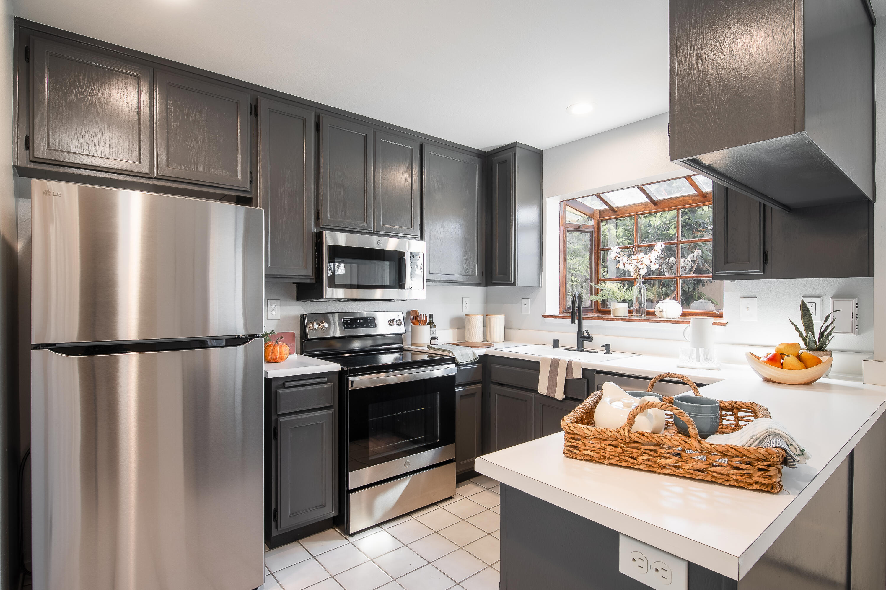 4344 Modoc Road, Unit 2 Santa Barbara, CA 93110 - Photo 11 of 28 a kitchen with stainless steel appliances granite countertop a refrigerator stove a sink dishwasher and microwave with wooden floor