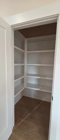 a view of walk in closet with empty racks