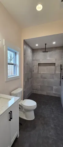 a bathroom with a sink a toilet and a shower