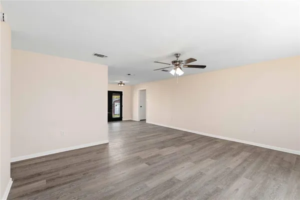 a view of a room with wooden floor and white walls