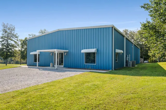 a front view of house with yard and trees