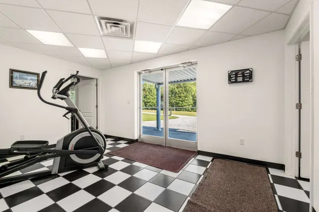 a living room with a black white checkered floor with couches and a coffee table