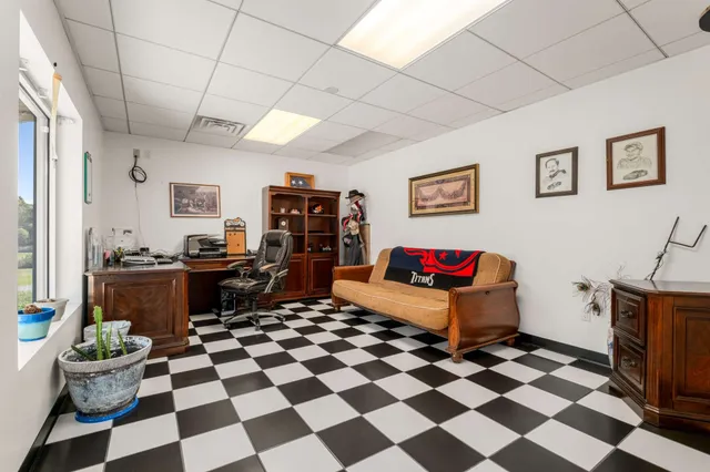 a bedroom with a bed dresser and a flat tv screen