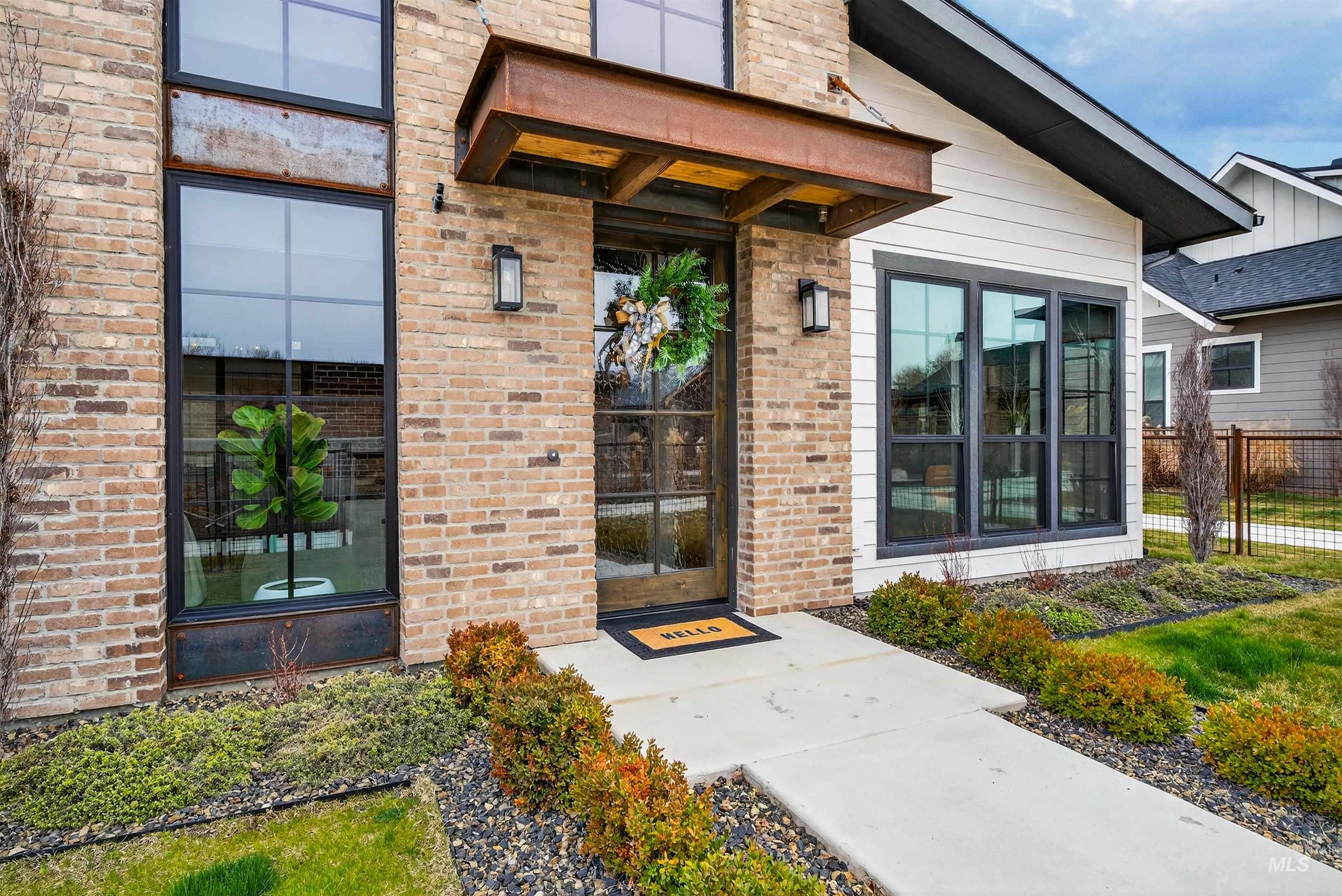 Entrance to property featuring brick siding