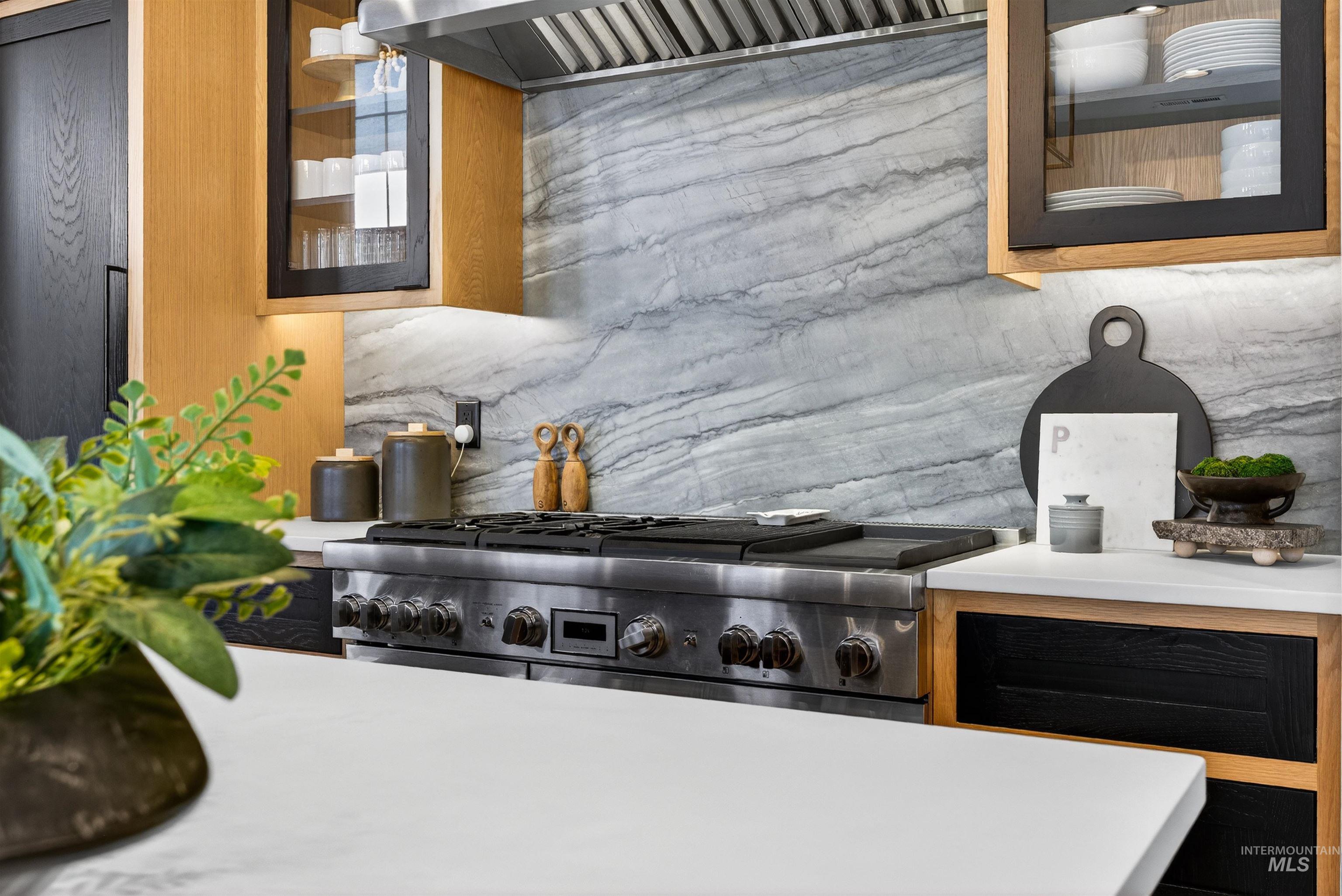 2526 West Rustic Forge Street Eagle, ID 83616 - Photo 26 of 50 Kitchen view of glass insert cabinets, high end range, and light stone countertops