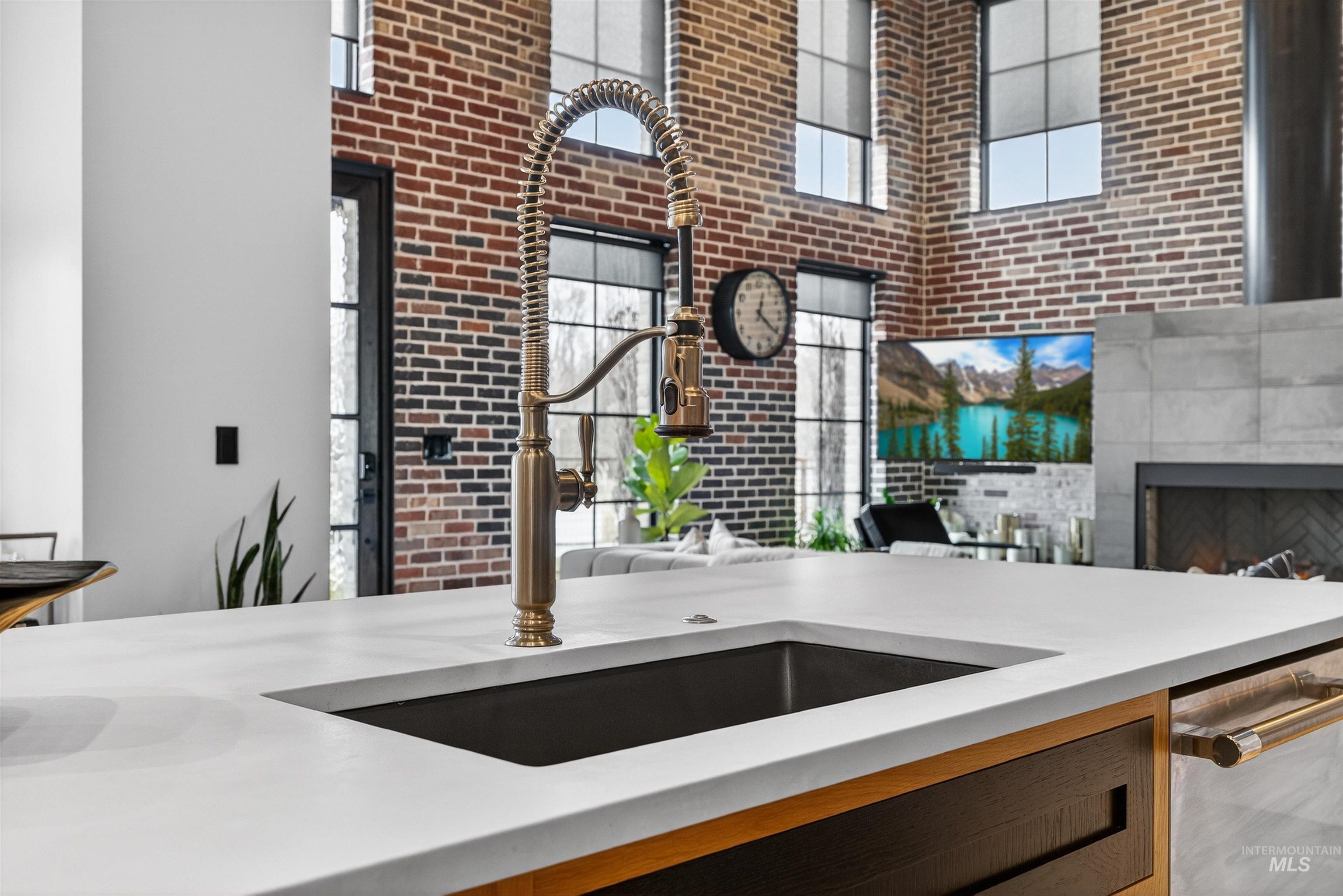 2526 West Rustic Forge Street Eagle, ID 83616 - Photo 50 of 50 Kitchen with a high ceiling, light stone counters, dishwasher, a tiled fireplace, and open floor plan