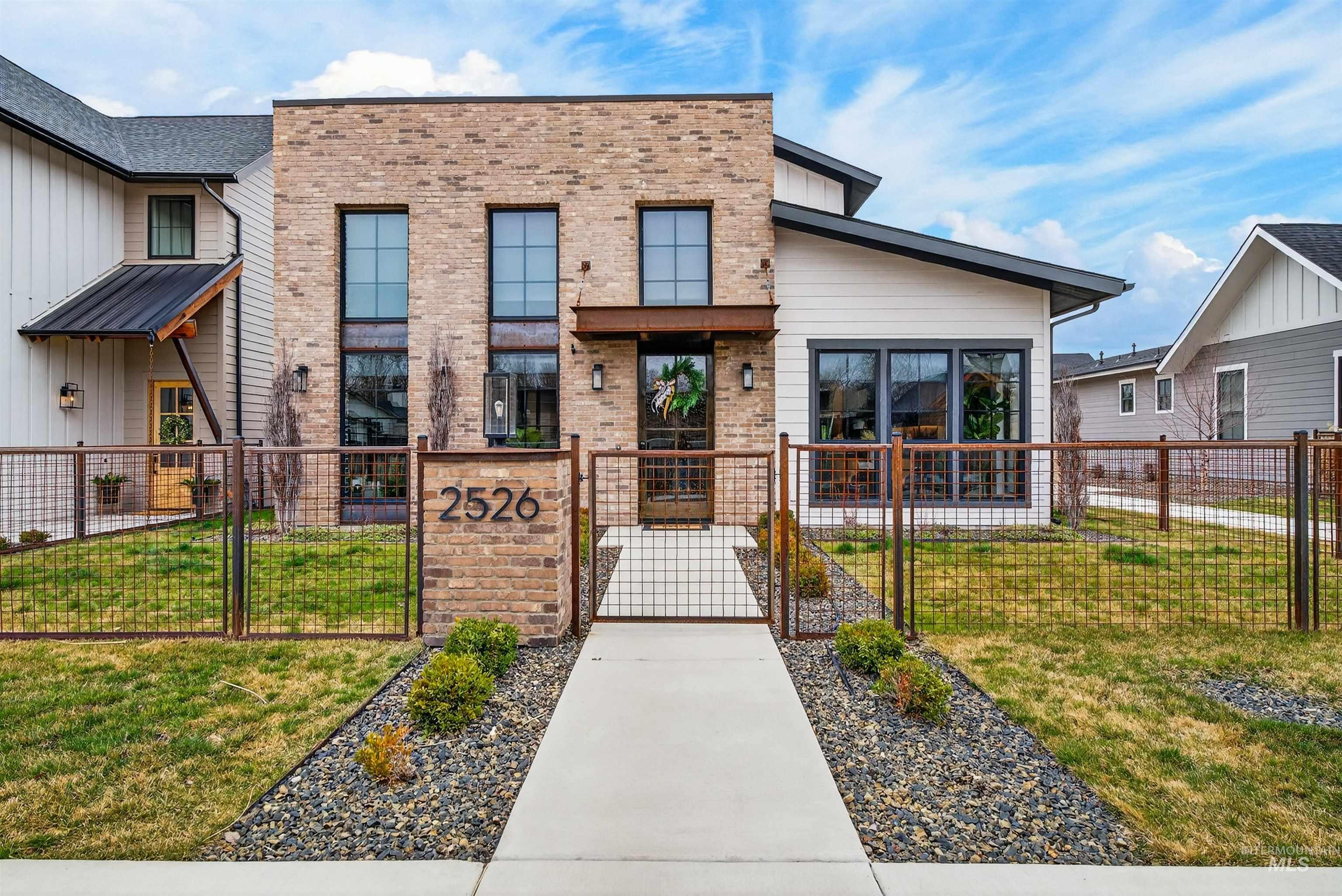 2526 West Rustic Forge Street Eagle, ID 83616 - Photo 3 of 50 View of building exterior featuring a fenced front yard
