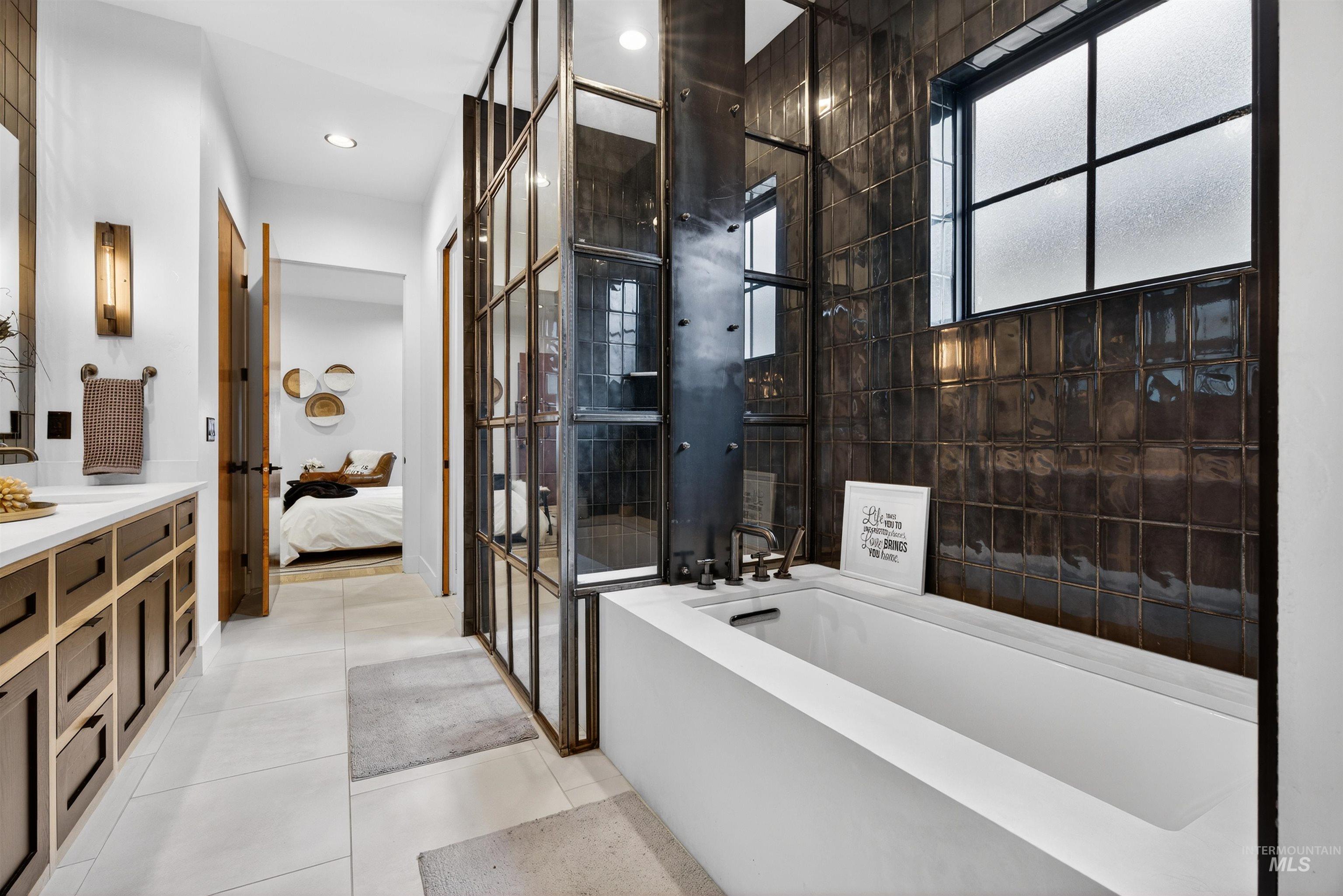 2526 West Rustic Forge Street Eagle, ID 83616 - Photo 32 of 50 Full bathroom with vanity, ensuite bath, a bathtub, a stall shower, and light tile patterned flooring