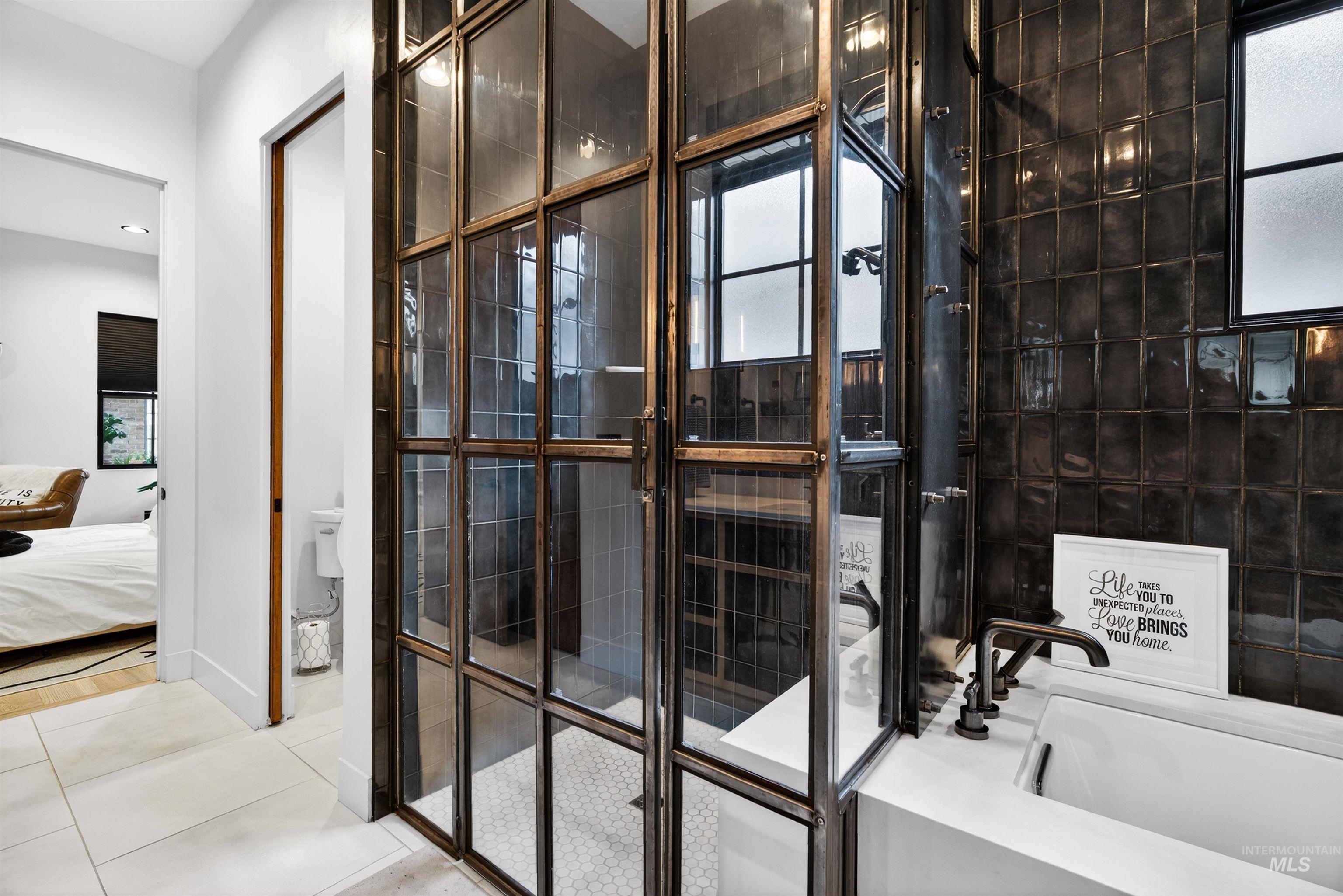 2526 West Rustic Forge Street Eagle, ID 83616 - Photo 34 of 50 Bathroom featuring ensuite bathroom, light tile patterned floors, a garden tub, and tiled shower