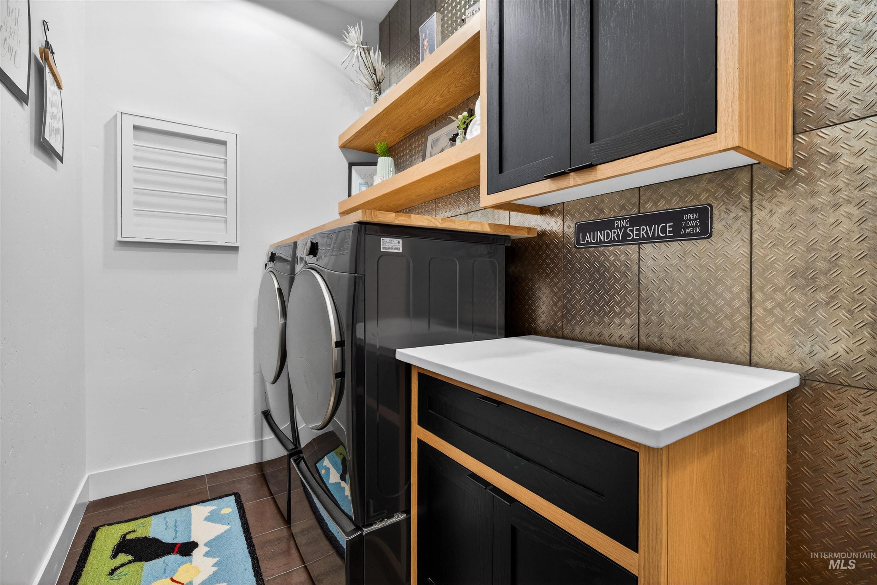 2526 West Rustic Forge Street Eagle, ID 83616 - Photo 46 of 50 Laundry room with dark tile patterned floors and washing machine and clothes dryer