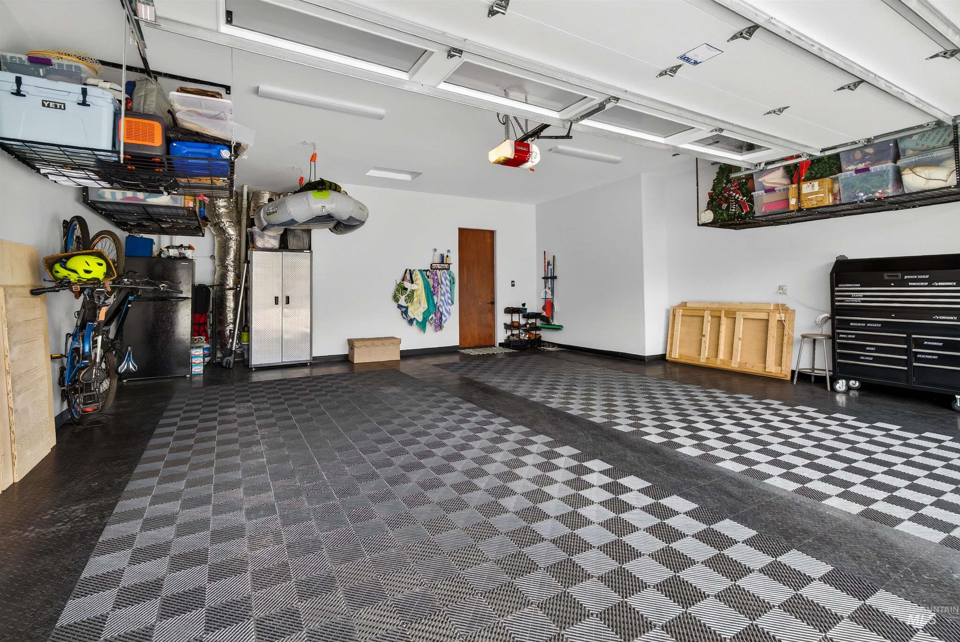 2526 West Rustic Forge Street Eagle, ID 83616 - Photo 47 of 50 Garage with freestanding refrigerator and a garage door opener