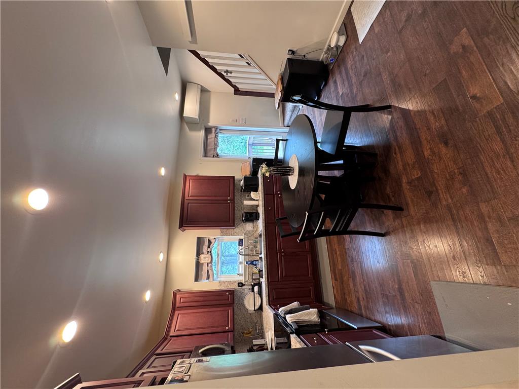 130 Hidden Spur Road Lehighton, PA 18235 - Photo 9 of 19 Rich hardwood flooring complements the deep-toned cabinetry in this practical kitchen, complete with modern recessed lighting.