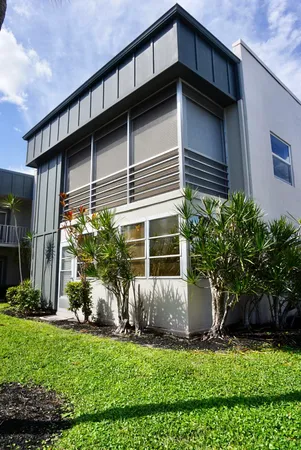 a view of a house with a yard and plants