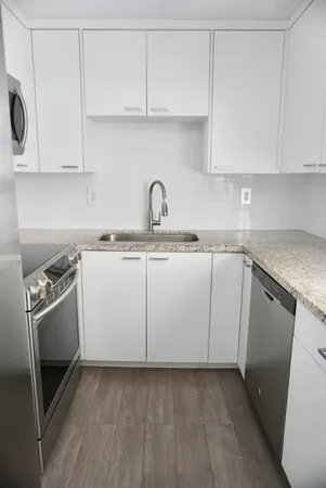 a kitchen with cabinets appliances and a sink