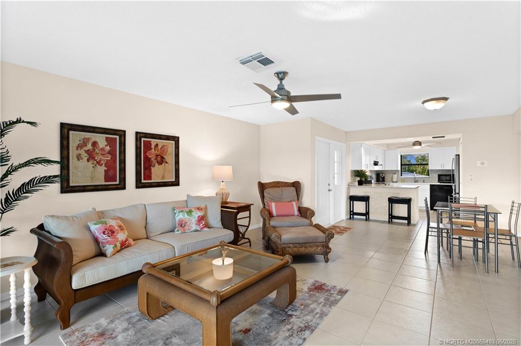 4885 Southeast Capstan Avenue, Unit E27 Stuart, FL 34997 - Photo 15 of 40 a living room with furniture and wooden floor