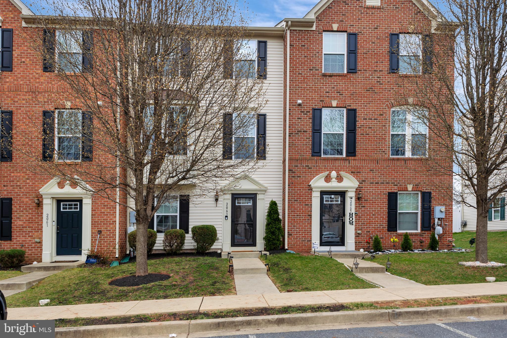 2063 Spring Run Circle Frederick, MD 21702 - Photo 1 of 28 front view of a brick house with a yard