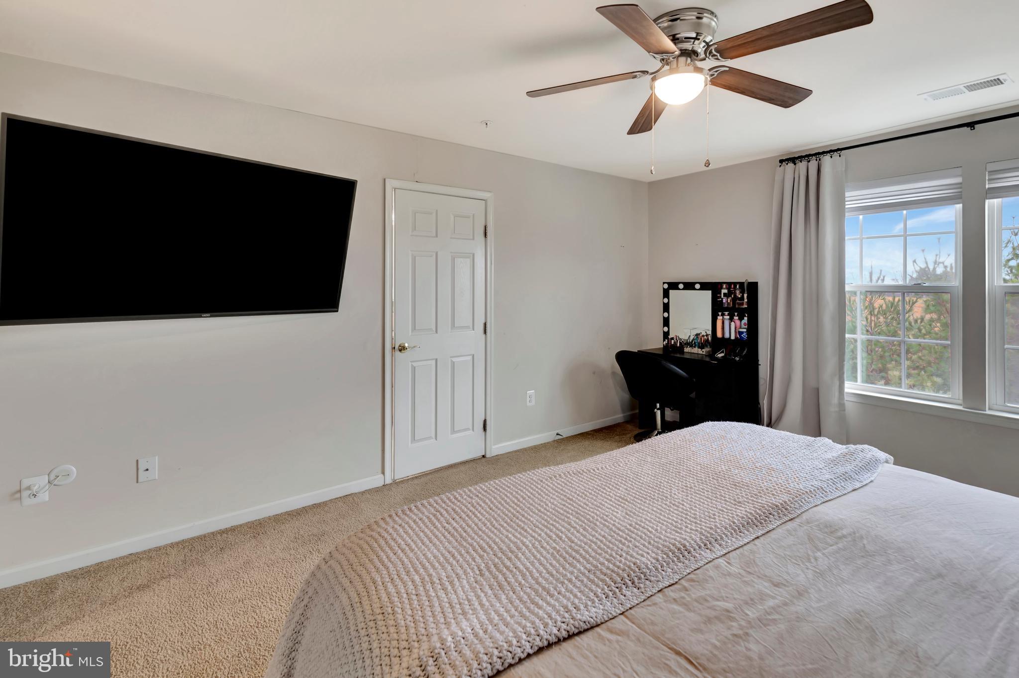 2063 Spring Run Circle Frederick, MD 21702 - Photo 19 of 28 a bedroom with a bed and a flat screen tv