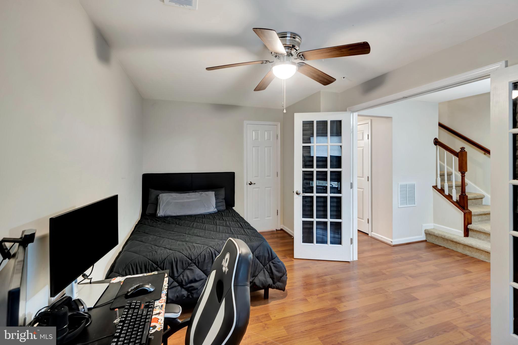 2063 Spring Run Circle Frederick, MD 21702 - Photo 7 of 28 a bedroom with a bed and a flat tv screen