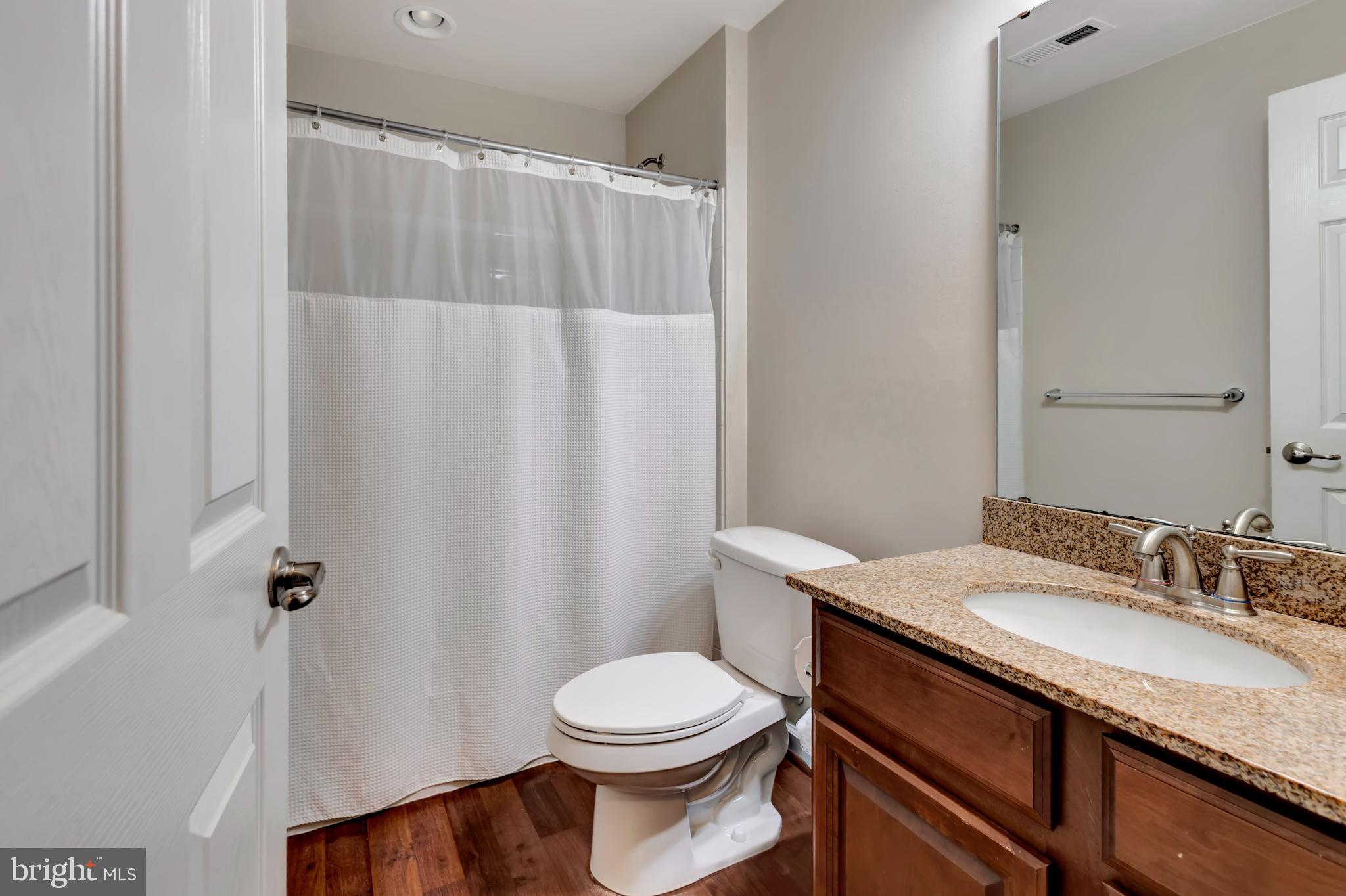 2063 Spring Run Circle Frederick, MD 21702 - Photo 8 of 28 a bathroom with a granite countertop sink toilet and a mirror