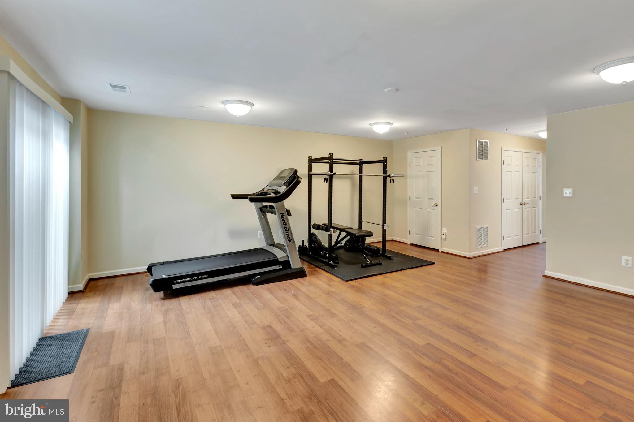 2063 Spring Run Circle Frederick, MD 21702 - Photo 10 of 28 a view of a room with gym equipment and wooden floor