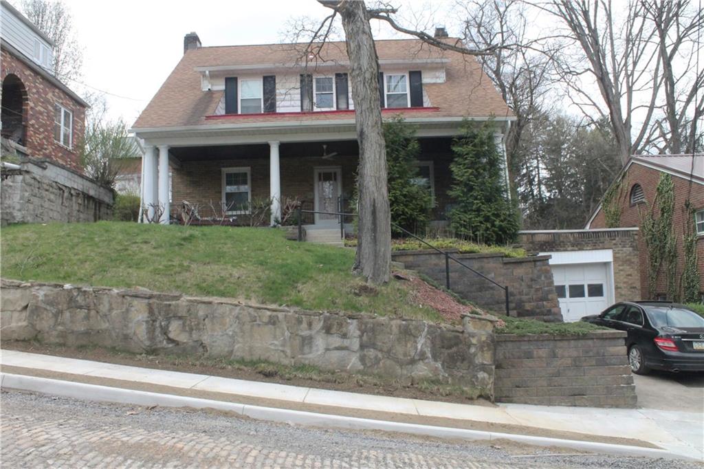 67 Warren Street Pittsburgh, PA 15205 - Photo 1 of 39 a front view of a house with a yard and garage