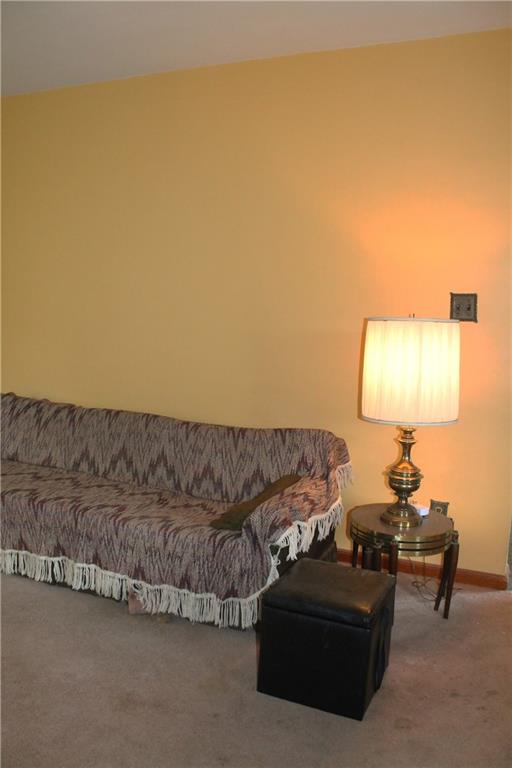 67 Warren Street Pittsburgh, PA 15205 - Photo 14 of 39 a living room with a couch and a lamp next to a window