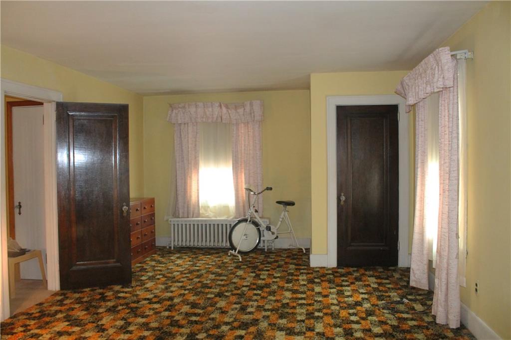 67 Warren Street Pittsburgh, PA 15205 - Photo 32 of 39 a bedroom with a bed and a chandelier