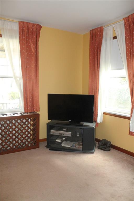 67 Warren Street Pittsburgh, PA 15205 - Photo 34 of 39 a living room with furniture and a flat screen tv
