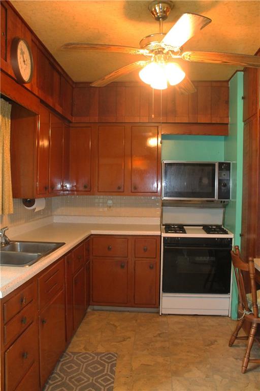 67 Warren Street Pittsburgh, PA 15205 - Photo 6 of 39 a kitchen with stainless steel appliances granite countertop a sink and a microwave