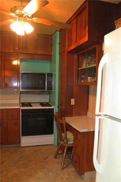 67 Warren Street Pittsburgh, PA 15205 - Photo 8 of 39 a kitchen with stainless steel appliances a stove a microwave and a refrigerator