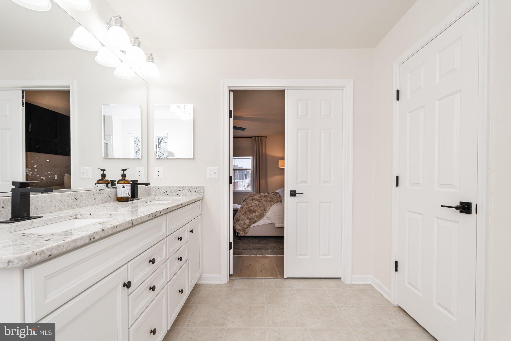 38 Deep Creek Road Ranson, WV 25438 - Photo 35 of 64 a bathroom with a granite countertop double vanity sink and mirror